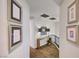 This naturally-lit hallway features wood floors and decorative wall art at 8928 Stafford Springs Dr, Las Vegas, NV 89134