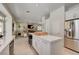 Bright kitchen with a center island, stainless steel appliances, and an open view to the living room at 8928 Stafford Springs Dr, Las Vegas, NV 89134