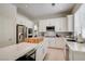 Open kitchen featuring stainless steel appliances, an island, and stylish white cabinetry at 8928 Stafford Springs Dr, Las Vegas, NV 89134