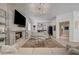 Spacious living area with a fireplace, wet bar, and a large flat-screen TV at 8928 Stafford Springs Dr, Las Vegas, NV 89134