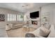 Bright living room with fireplace, large windows and modern lighting at 8928 Stafford Springs Dr, Las Vegas, NV 89134