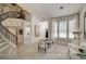 Bright living room featuring tile floors, staircase, and modern furniture arrangement at 8928 Stafford Springs Dr, Las Vegas, NV 89134