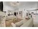 Spacious living room with a view of the kitchen, featuring stylish furniture and decor at 8928 Stafford Springs Dr, Las Vegas, NV 89134