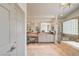 Beautiful main bathroom with double vanity, large mirror, standalone shower and separate tub at 8928 Stafford Springs Dr, Las Vegas, NV 89134