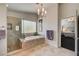 This beautiful bathroom is bright with a standalone shower, soaking tub, and neutral colors at 8928 Stafford Springs Dr, Las Vegas, NV 89134