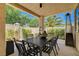 Covered patio features outdoor dining set with views of landscaped backyard and privacy wall at 8928 Stafford Springs Dr, Las Vegas, NV 89134
