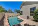 Inviting backyard pool with rock accents and tanning ledge, ideal for enjoying the outdoors at 8928 Stafford Springs Dr, Las Vegas, NV 89134