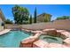 Backyard pool and spa combo with rock features, perfect for relaxation and outdoor enjoyment at 8928 Stafford Springs Dr, Las Vegas, NV 89134