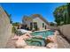 Backyard oasis with a luxurious pool, spa, and covered patio, perfect for entertaining guests at 8928 Stafford Springs Dr, Las Vegas, NV 89134