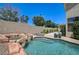 Backyard pool featuring a rock waterfall and landscaped surroundings at 8928 Stafford Springs Dr, Las Vegas, NV 89134