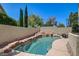 Beautiful pool area with rock waterfall feature and lush landscaping, perfect for relaxing on sunny days at 8928 Stafford Springs Dr, Las Vegas, NV 89134