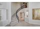 Elegant staircase with black railing, light tile steps, and large art piece, with high ceilings at 8928 Stafford Springs Dr, Las Vegas, NV 89134