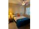 Cozy bedroom with a full-size bed, ceiling fan, and window with plantation shutters, providing natural light and privacy at 9050 W Warm Springs Rd # 1092, Las Vegas, NV 89148