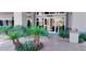 Building entrance adorned with a well-maintained garden and featuring a modern glass door design at 9050 W Warm Springs Rd # 1092, Las Vegas, NV 89148