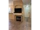 Inviting living room with a fireplace, TV, and neutral tile flooring near the front door at 9050 W Warm Springs Rd # 1092, Las Vegas, NV 89148