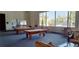 Recreation room with two pool tables, tables, seating and plenty of natural light from the large windows at 9050 W Warm Springs Rd # 1092, Las Vegas, NV 89148