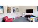 room with a large flat-screen TV, cartoon posters, comfortable furniture and an array of toys at 9050 W Warm Springs Rd # 1092, Las Vegas, NV 89148