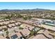 An aerial view of the residential community showing nearby mountains, desert landscape, and various home styles at 9233 Onyx Point Ct, Henderson, NV 89074