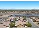 Aerial view of the residential community with nearby highway, carports, and mountain views at 9233 Onyx Point Ct, Henderson, NV 89074