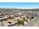 An aerial view of a desert homes featuring solar panels, neutral color schemes, and community pool on a sunny day at 9233 Onyx Point Ct, Henderson, NV 89074