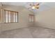 Bedroom features vaulted ceiling, a fan, and wood blinds covering two windows at 9233 Onyx Point Ct, Henderson, NV 89074
