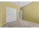 Bedroom with sliding closet doors, tan carpet, and cream colored walls at 9233 Onyx Point Ct, Henderson, NV 89074