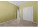 Bedroom with sliding closet doors, tan carpet, and cream colored walls at 9233 Onyx Point Ct, Henderson, NV 89074