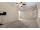 Spacious carpeted bedroom with ceiling fan and an arched entryway at 9233 Onyx Point Ct, Henderson, NV 89074