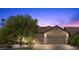 Charming single-story home featuring desert landscaping, a tile roof, and a spacious three-car garage at 9233 Onyx Point Ct, Henderson, NV 89074