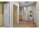 Hallway with tan walls, tile flooring, and recessed alcoves for storage or decoration at 9233 Onyx Point Ct, Henderson, NV 89074