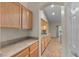 Long kitchen with countertops and cabinets featuring laminate countertops at 9233 Onyx Point Ct, Henderson, NV 89074