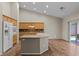 Bright, open kitchen features an island, stainless steel appliances, wood cabinets, and tile backsplash at 9233 Onyx Point Ct, Henderson, NV 89074