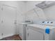 Laundry room featuring a washer, dryer, overhead storage, and white door at 9233 Onyx Point Ct, Henderson, NV 89074