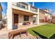 Backyard featuring artificial grass, a covered patio, and comfortable seating at , Las Vegas, NV 89166