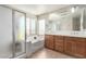 Bright bathroom features a soaking tub, frosted glass shower, and double sink vanity with natural lighting at , Las Vegas, NV 89166