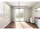 Sun-drenched dining area with sliding glass doors leading to the backyard and a stylish light fixture at , Las Vegas, NV 89166