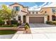Inviting two-story home featuring a tidy lawn, neutral paint, and two-car garage at , Las Vegas, NV 89166
