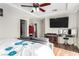 Well-lit main bedroom featuring a tray ceiling, ceiling fan, and built-in entertainment center at , Las Vegas, NV 89166