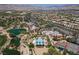 An aerial view of the community featuring a pool, lake, and well-manicured landscaping at 10240 Notte Ave, Las Vegas, NV 89135