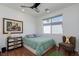Well-lit bedroom featuring a double bed, ceiling fan, and a large window at 10240 Notte Ave, Las Vegas, NV 89135