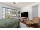 Comfortable bedroom features a large window, cozy chair, and neutral tones at 10240 Notte Ave, Las Vegas, NV 89135