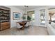 Bright dining area with stylish light fixture, view to backyard and adjacent to living area at 10240 Notte Ave, Las Vegas, NV 89135