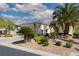 Beautiful single-story home with desert landscaping, mature palm trees and an American flag at 10240 Notte Ave, Las Vegas, NV 89135