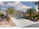 Charming single-story home featuring a two-car garage, desert landscaping and mature palm trees at 10240 Notte Ave, Las Vegas, NV 89135