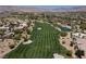 Scenic golf course view showcasing lush green fairways, mature trees, and a beautiful pond at 10240 Notte Ave, Las Vegas, NV 89135