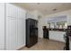 Spacious kitchen featuring granite counters, stainless-steel appliances, white cabinetry and tile flooring at 10240 Notte Ave, Las Vegas, NV 89135