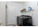 Laundry room with front loading washer and dryer, and built-in shelving for storage at 10240 Notte Ave, Las Vegas, NV 89135