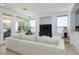 Open living room featuring large windows providing natural light and view of the covered patio at 10240 Notte Ave, Las Vegas, NV 89135