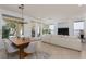 Open concept living room with a dining area and modern furnishings, filled with natural light at 10240 Notte Ave, Las Vegas, NV 89135