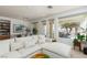 Open living room featuring view into dining area, large windows and a comfortable sectional at 10240 Notte Ave, Las Vegas, NV 89135
